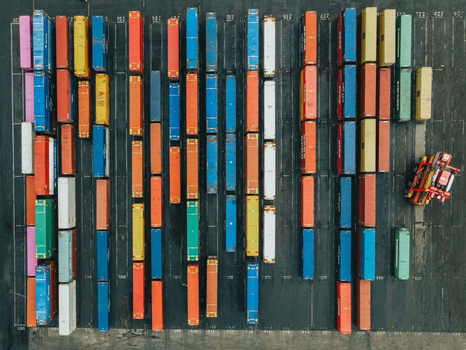 Aerial view of a busy container port at scale